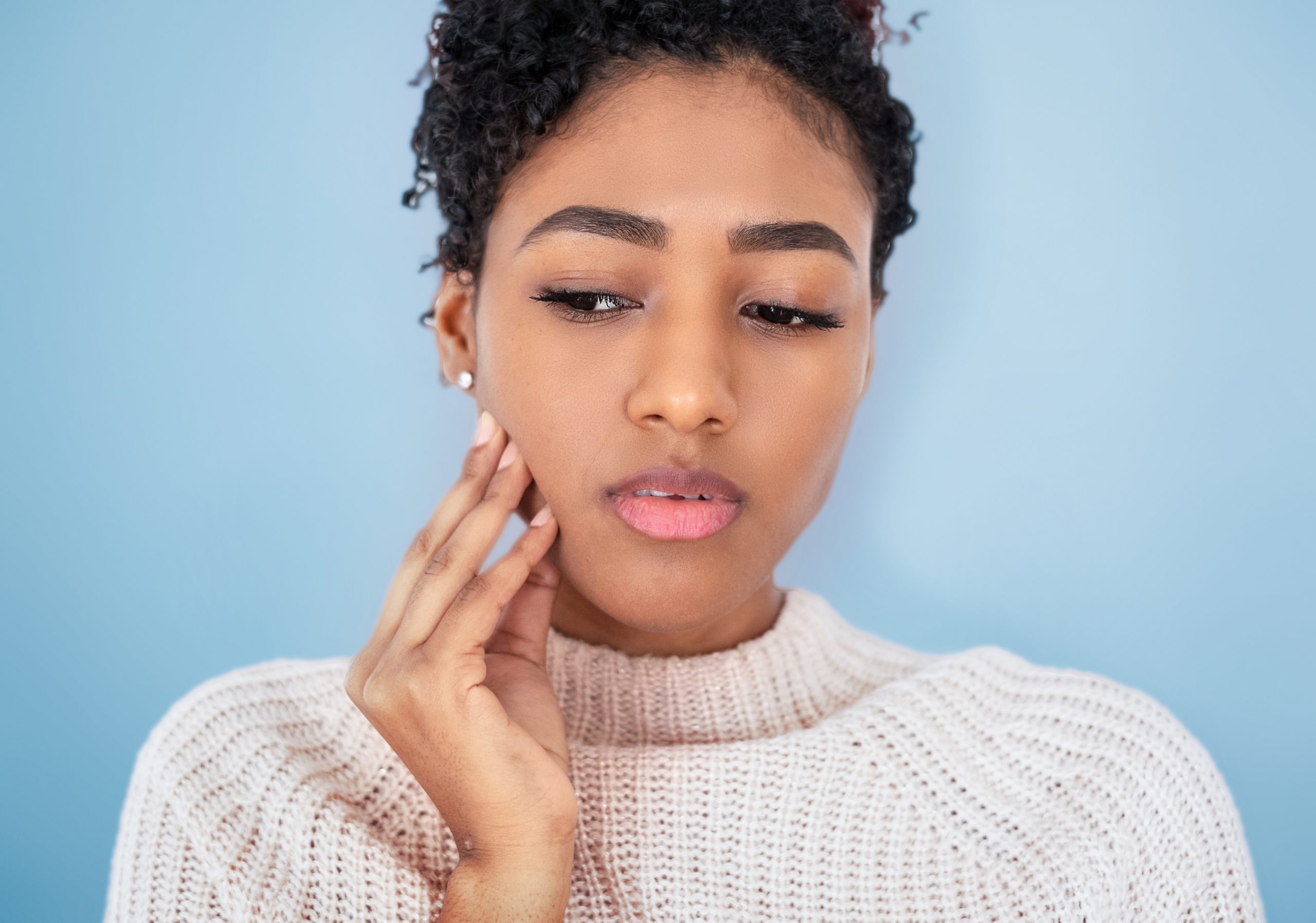 Studio shot of black woman feeling bad toothache